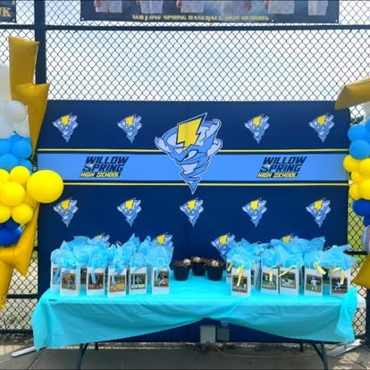 Willow Spring High School senior night table with balloon garland and gift bags