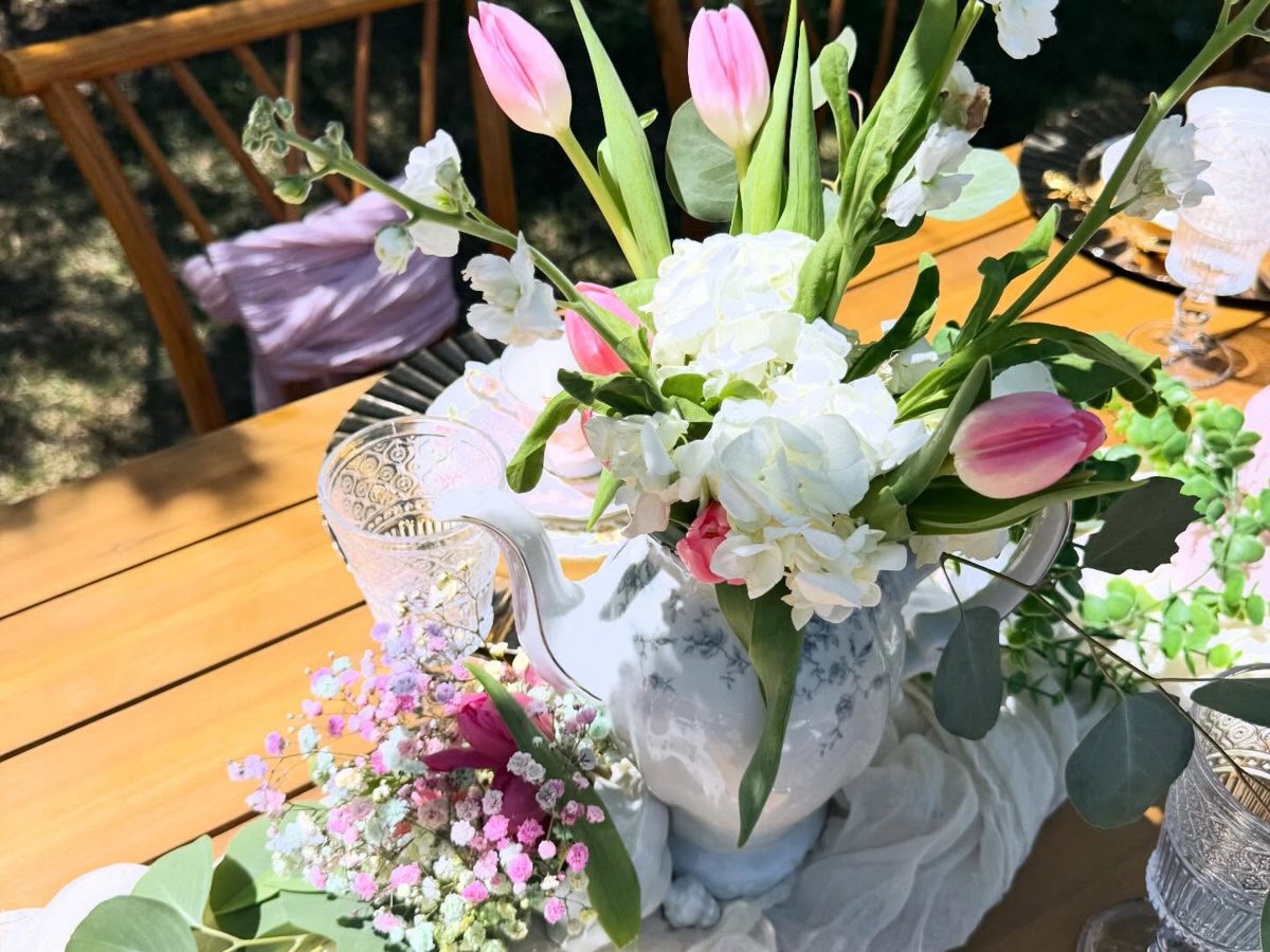 Pink tulips and white hydrangea arranged in a vintage blue and white teapot